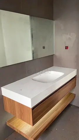 Custom Made Bathroom Wash Basin Vanity Featuring a Solid Stone Integrated Sink, Warm Natural Wood Ca