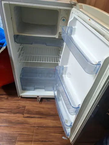Used single-door refrigerator with small freezer compartment - cleanable, functional