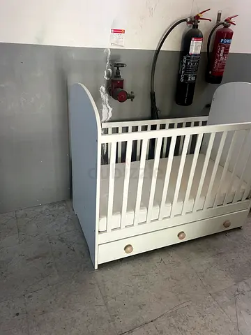 White wooden baby crib with storage drawers - good condition