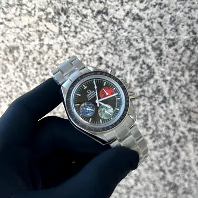 The watch appears to be an Omega Speedmaster Professional Moonwatch "From the