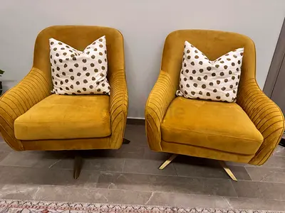 Pair of mustard velvet swivel armchairs