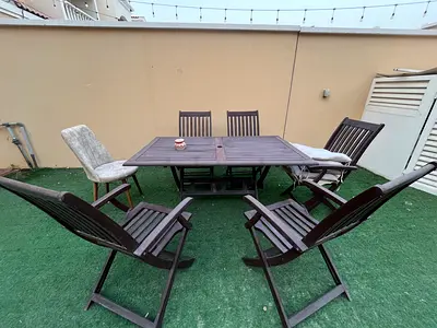 Outdoor wooden dining table with 5 folding chairs - used