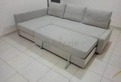Light grey L-shaped sofa bed with storage - good condition