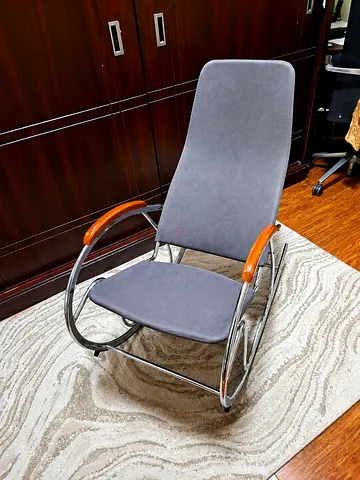 Modern grey fabric rocking chair with chrome frame and wooden armrests