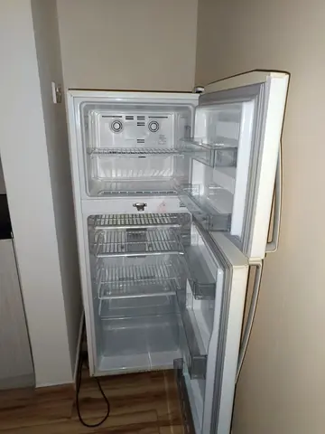 Used double-door refrigerator with top freezer - good working condition