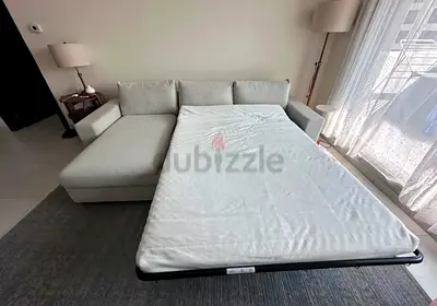 Light Grey L-shaped Sofa with Pull-out Bed - Good Condition