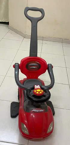 Red push ride-on car with parent handle and safety bar - good condition
