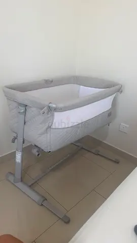 Gray bedside bassinet / cradle - adjustable height, good condition