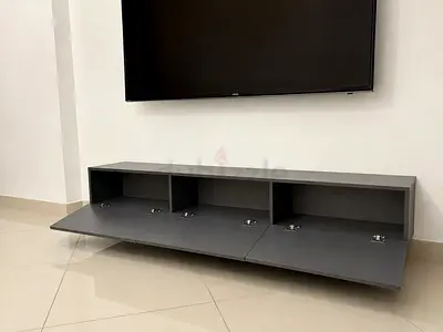 Wall-mounted low TV cabinet with flip-down doors - modern grey