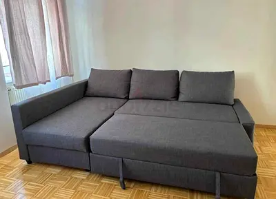 Dark grey L-shaped sofa bed with storage - good condition