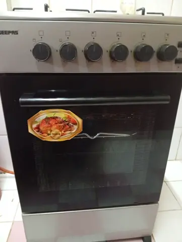 Used Geepas Gas Oven and Stove with medium cylinder - 4 Burner Cooker in Good Working Condition