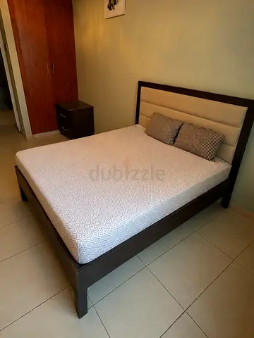 Queen wooden bed frame with upholstered headboard - good condition with mattress