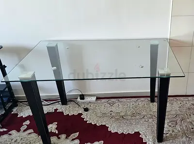 Glass Top Dining Table with Dark Wooden Legs - Good Condition. No chairs