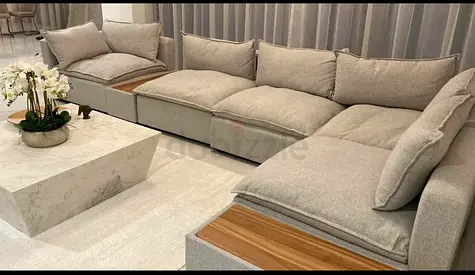 Light grey modular corner sofa with wooden arm inserts - good condition