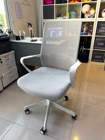 Light grey mesh ergonomic office chair with armrests and wheels