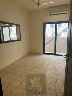 For annual rent in Al Butina, one bedroom and living room with split AC in a prime location. Rent AE