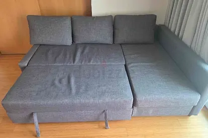 Grey fabric L-shape sofa bed with pull out section