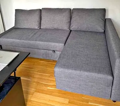 Grey fabric sofa bed with cushions