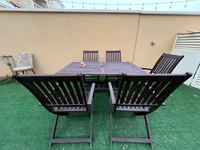 Outdoor wooden dining table with 5 folding chairs - used
