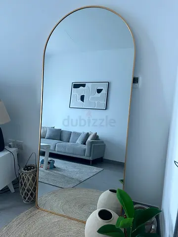 Large arched full-length mirror with slim gold frame