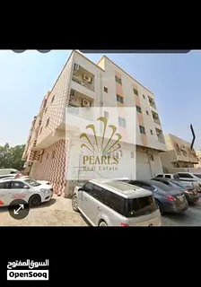 "Investment building for sale in Ajman 31 apartments and 5 shops fully rented on three main streets