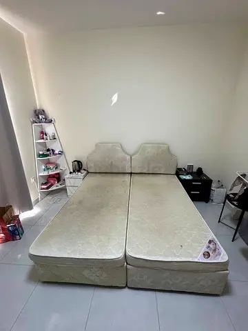 Pair of single beds with mattresses and matching headboards