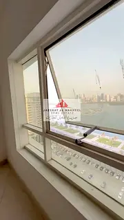 Three-bedroom apartment with a living room in Al Majaz 3, with a full sea view.