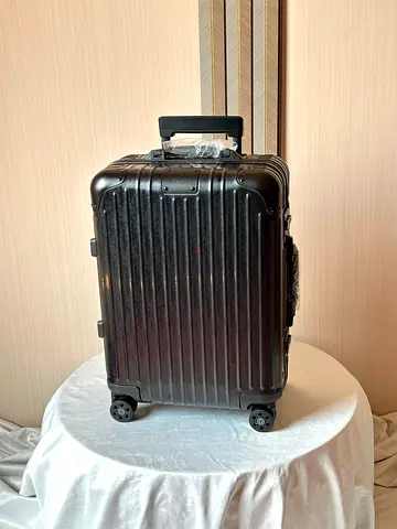 Dior and Rimowa carry on suitcase