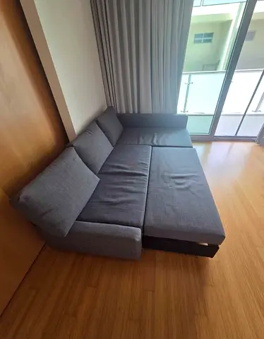 Grey fabric L-shape sofa bed with pull out section