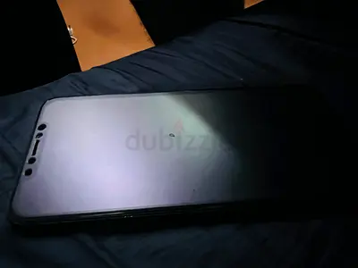 Used smartphone with tempered glass screen protector - good condition