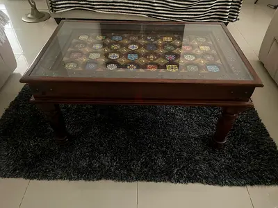 Wooden coffee table with decorative inlay and glass top. Vintage piece