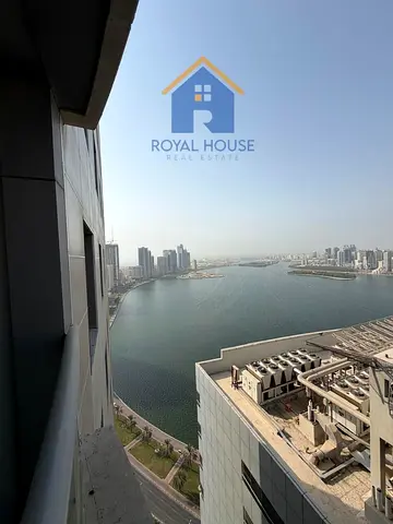 For sale: A distinctive two-bedroom apartment with a living room, boasting a stunning open view of Khalid Lagoon, and featuring a private parking spac