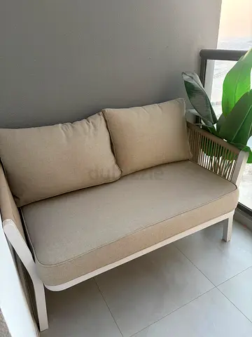 Set of 2 compact two-seater outdoor/indoor sofas in beige with white frame and coffee table
