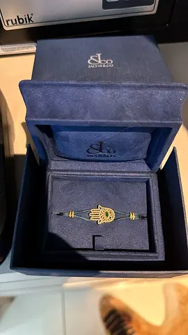 Green cord Hamsa bracelet with gold charm in box