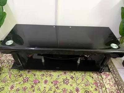 Black glass TV stand with lower shelf and chrome legs