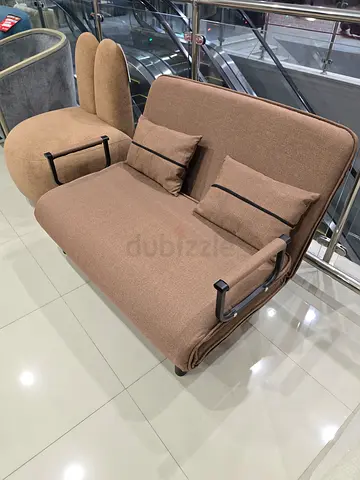 Convertible single sofa bed / recliner in beige fabric with cushions