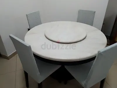 Round marble-top dining table with 4 chairs and lazy Susan