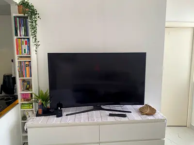 Samsung 55-inch Smart TV. Note: There are a few light spots on the screen, but they do not affect vi