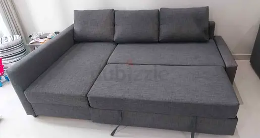 Grey L-shaped sofa bed with storage – good condition