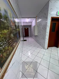 Spacious studio for rent in Al Majaz 2, Sharjah, featuring a separate kitchen, balcony, and central