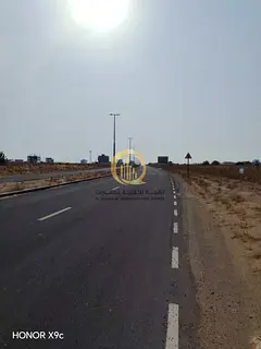 Two residential plots in Al-Zubair Gardens, building permit for a villa ground floor + 2, in a prime