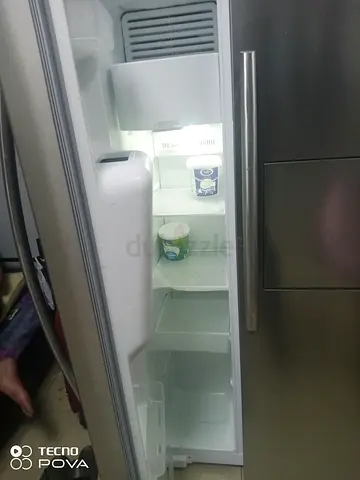 Used side-by-side stainless steel refrigerator with ice/water dispenser