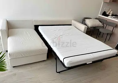 Light beige fabric sofa with pull-out bed - good condition