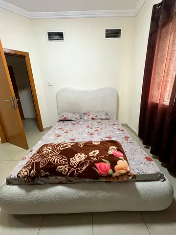 White upholstered double bed frame with mattress (used)