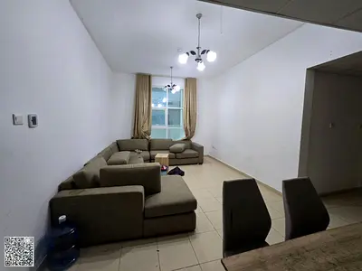 **Two-bedroom apartment with a living room and balcony for sale, featuring access to a gym, swimming pool, free parking, and a kids' play area.**