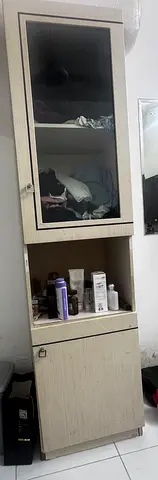 Tall storage cabinet with glass door and drawer - light wood finish