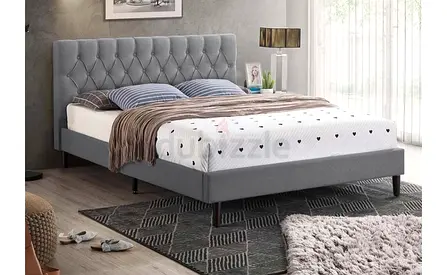 Grey upholstered king bed with tufted headboard
