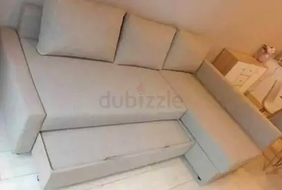 Light grey L-shaped sofa with storage - good condition