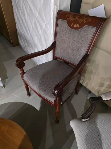 Classic wooden armchair with upholstered seat and carved details
