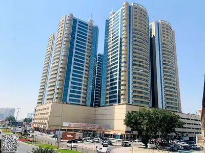 Studio for sale in Horizon Towers - Ajman - Separate kitchen, central air conditioning, and private parking.